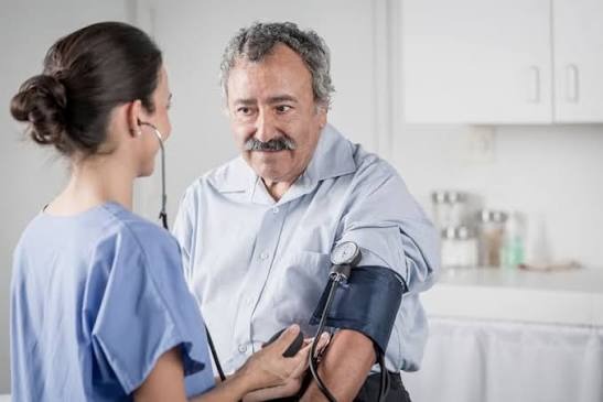 Patient having blood pressure checked